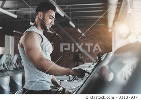Serene male pressing button on race track Serene male pressing button on race track 33137937
