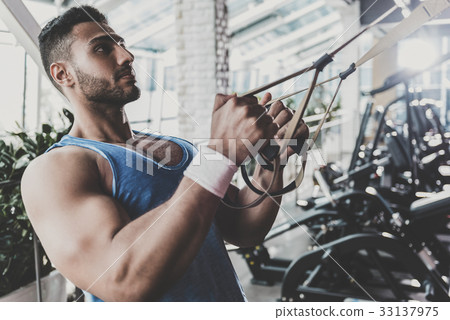 Calm man working out in keep-fit studio 33137975