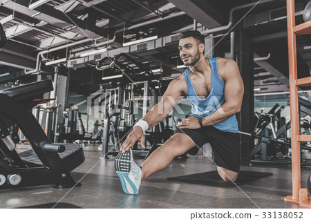 Satisfied bearded athlete taking physical exercise 33138052