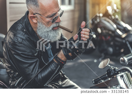 Old biker wants to smoke Old biker wants to smoke 33138145