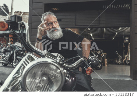 Thoughtful elder man ready for ride 33138317