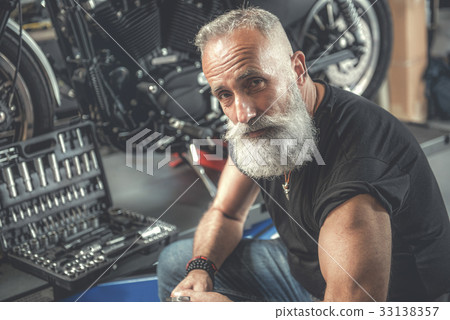 Assured aged man in workshop 33138357