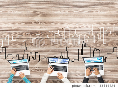 Top view of businesspeople sitting at table and using gadgets 33144184