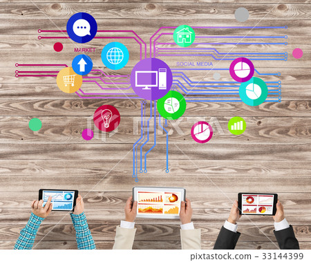 Top view of businesspeople sitting at table and using gadgets Top view of businesspeople sitting at table and using gadgets 33144399