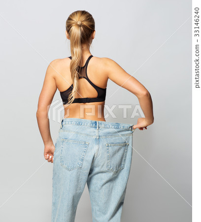 young slim sporty woman in oversize pants 33146240
