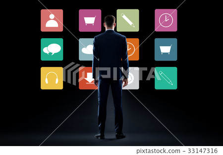 businessman in suit looking at virtual menu icons businessman in suit looking at virtual menu icons 33147316