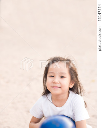 happy Asian child on a seesaw in sunset light happy Asian child on a seesaw in sunset light 33147354