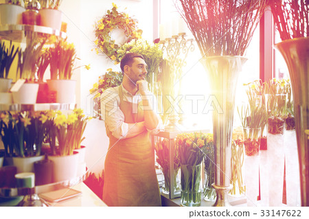 florist man or seller at flower shop 33147622
