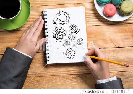 Businesswoman sketching in notepad 33148101