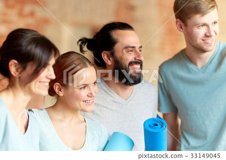 group of people with mats at yoga studio or gym 33149045
