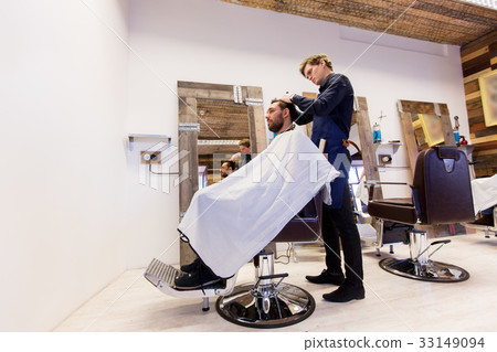 man and barber cutting hair at barbershop man and barber cutting hair at barbershop 33149094