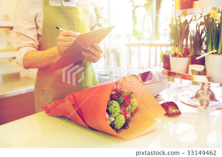 close up of man with clipboard at flower shop close up of man with clipboard at flower shop 33149462