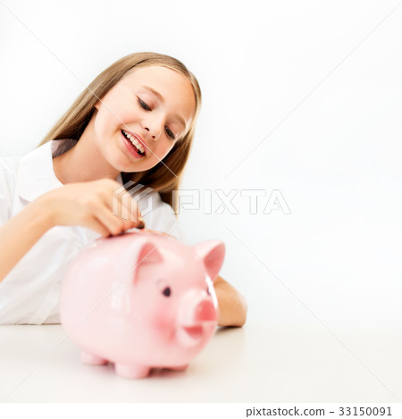 happy smiling girl putting coin into piggy bank happy smiling girl putting coin into piggy bank 33150091