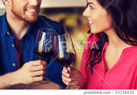 happy couple dining and drink wine at restaurant 33150410