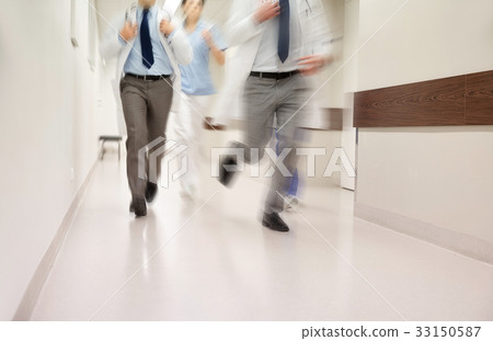 close up of medics or doctors running at hospital 33150587