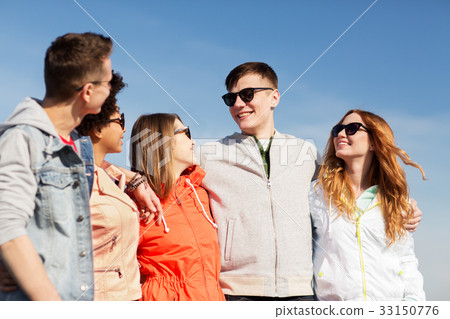 happy teenage friends in shades talking on street happy teenage friends in shades talking on street 33150776