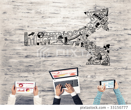 Top view of businesspeople sitting at table and using gadgets Top view of businesspeople sitting at table and using gadgets 33150777
