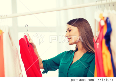 happy woman choosing clothes at home wardrobe happy woman choosing clothes at home wardrobe 33151073