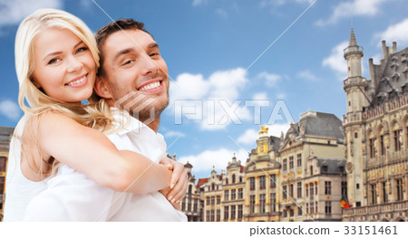 happy couple over grand place in brussels 33151461