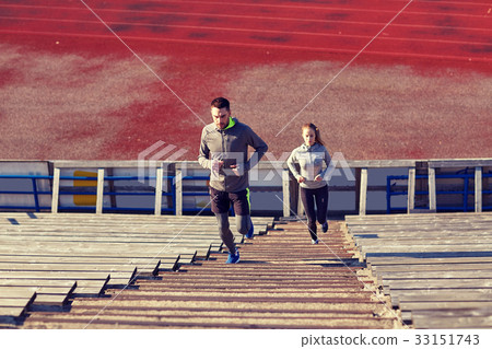 couple running upstairs on stadium 33151743