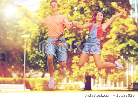 happy teenage couple jumping at summer park 33152026
