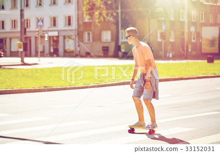teenage boy on skateboard crossing city crosswalk teenage boy on skateboard crossing city crosswalk 33152031
