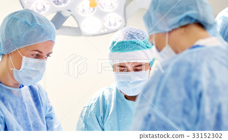 group of surgeons in operating room at hospital 33152302