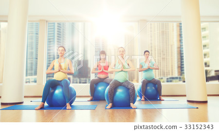 happy pregnant women exercising on fitball in gym happy pregnant women exercising on fitball in gym 33152343
