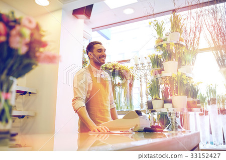 florist man or seller at flower shop counter 33152427