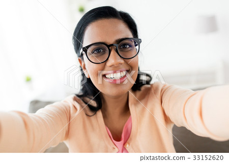 happy smiling woman taking selfie at home happy smiling woman taking selfie at home 33152620