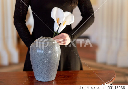 woman with cremation urn at funeral in church woman with cremation urn at funeral in church 33152688