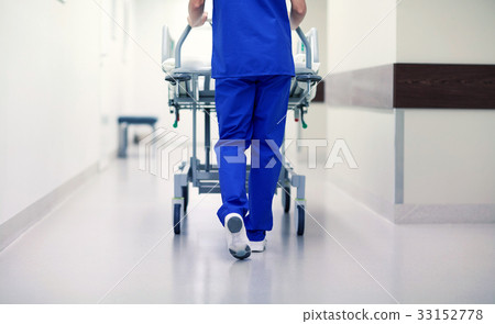 nurse carrying hospital gurney to emergency room 33152778