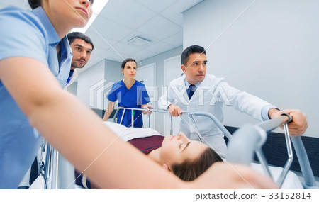 medics with woman on hospital gurney at emergency medics with woman on hospital gurney at emergency 33152814