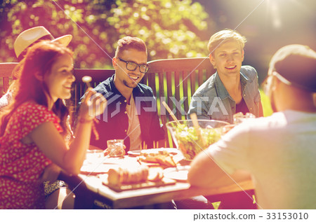 happy friends having dinner at summer garden party 33153010