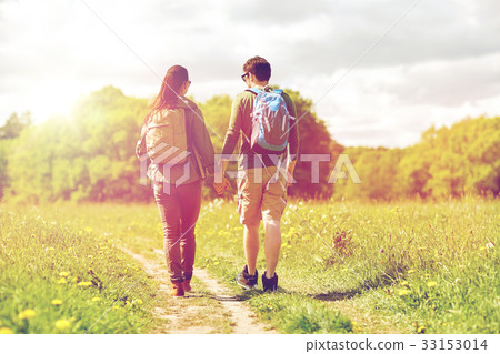 happy couple with backpacks hiking outdoors happy couple with backpacks hiking outdoors 33153014