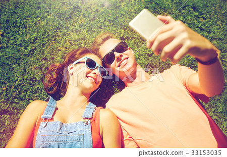 happy couple taking selfie on smartphone at summer 33153035
