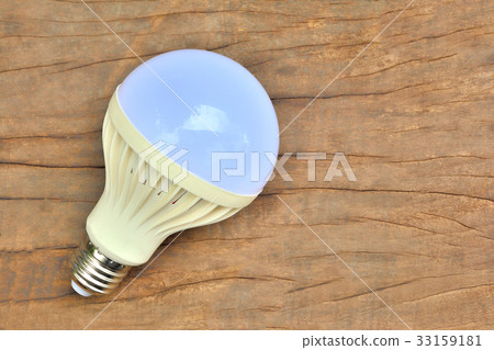 light bulb  on brown wooden tabl 33159181