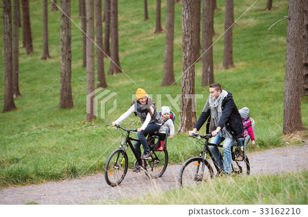 Young family in warm clothes cycling in autumn 33162210