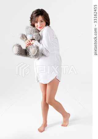 Pregnant woman holding soft toy. Pretty young Pregnant woman holding soft toy. Pretty young 33162455