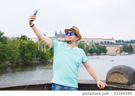 Handsome man is taking a selfie outdoor - 33164399