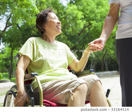 senior man with her disabled wife on wheelchair 33164514