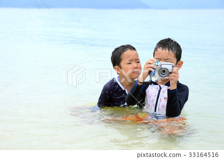 Child taking underwater camera Child taking underwater camera 33164516
