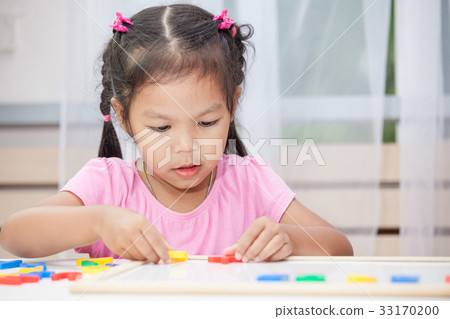 child girl play and learn magnetic alphabets child girl play and learn magnetic alphabets 33170200