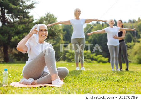 Smiling woman wiping her head with towel 33170789