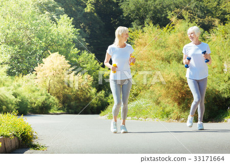 Positive healthy females looking at each other Positive healthy females looking at each other 33171664