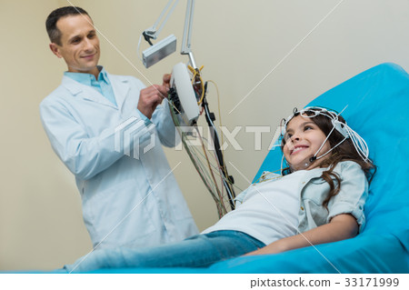 Medical specialist conducting encephalography of 33171999