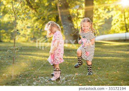 The cute little blond girls in rubber boots 33172194
