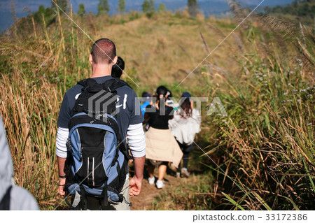 hikers trekking across the mountain 33172386