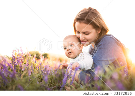 Young mother in nature with baby son in the arms. 33172936