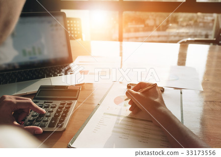 Close up Businessman using calculator and laptop 33173556